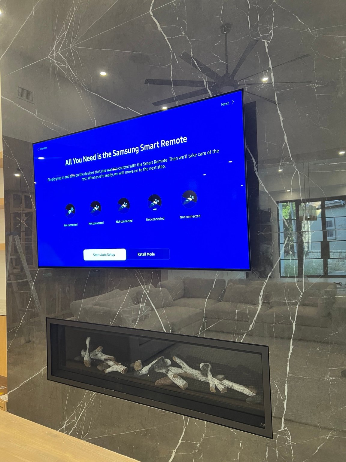 Smart Solutions TX television installation on a marble fireplace wall