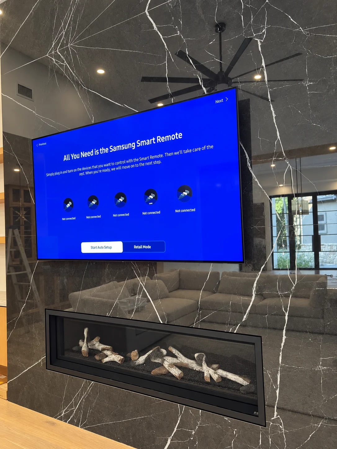 TV mounted on a polished marble fireplace wall in Central Texas